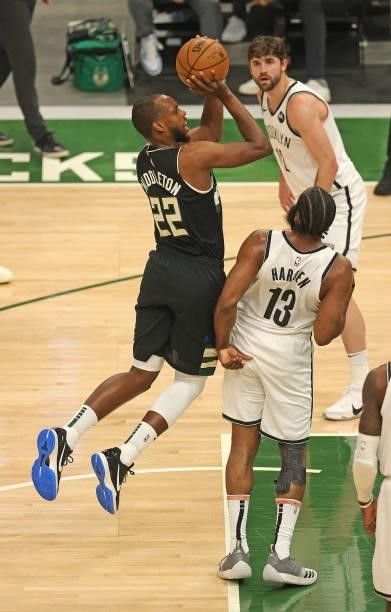 Khris Middleton of the Milwaukee Bucks is fouled while shooting by James Harden of the Brooklyn Nets at Fiserv Forum on June 17, 2021 in Milwaukee,...