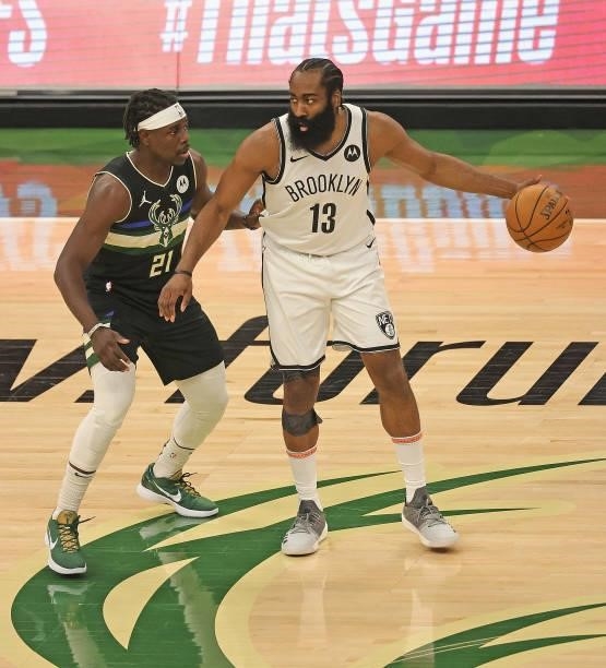 James Harden of the Brooklyn Nets moves against Jrue Holiday of the Milwaukee Bucks at Fiserv Forum on June 17, 2021 in Milwaukee, Wisconsin. The...