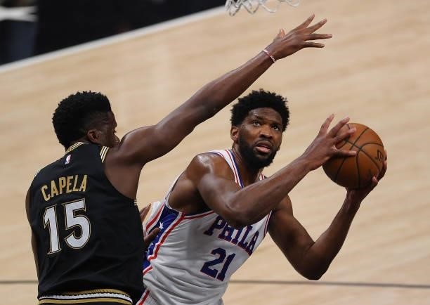 Joel Embiid of the Philadelphia 76ers attacks the basket against Clint Capela of the Atlanta Hawks during the first half of game 6 of the Eastern...