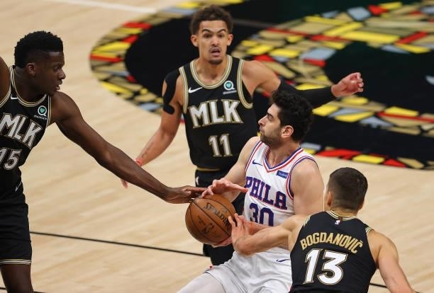 Furkan Korkmaz of the Philadelphia 76ers loses the ball as he draws a foul from Bogdan Bogdanovic of the Atlanta Hawks during the first half of game...