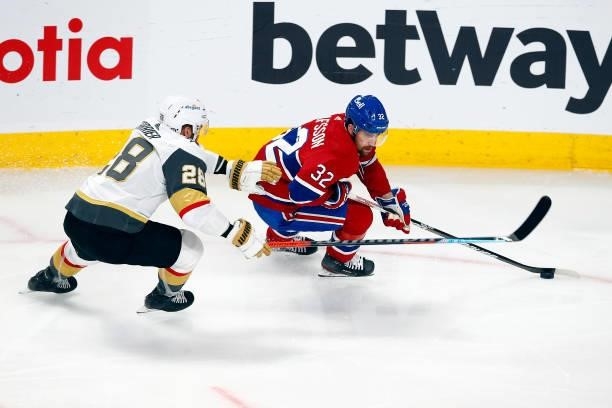 Erik Gustafsson of the Montreal Canadiens is defended by William Carrier of the Vegas Golden Knights during the first period in Game Three of the...