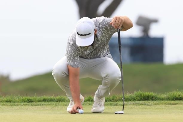 Matthew Wolff of the United States places his ball on the 14th green during the second round of the 2021 U.S. Open at Torrey Pines Golf Course on...