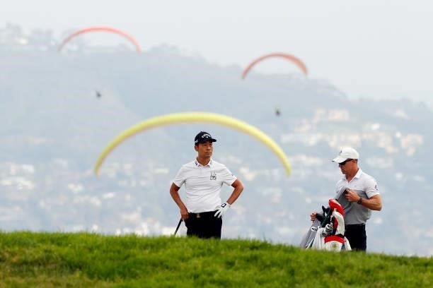 Kevin Na of the United States waits with caddie Kenny Harms on the fourth fairway during the second round of the 2021 U.S. Open at Torrey Pines Golf...