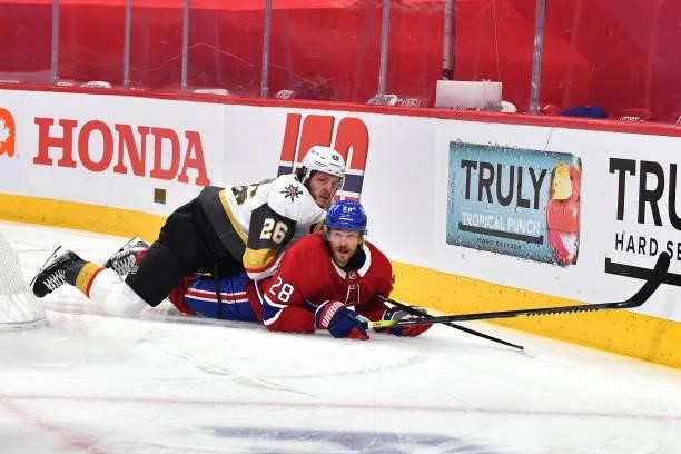 Jon Merrill of the Montreal Canadiens is hit by Mattias Janmark of the Vegas Golden Knights during the first period in Game Three of the Stanley Cup...