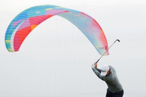 Bernd Wiesberger of Austria plays a third shot on the fourth hole as a paraglider is seen in the background during the second round of the 2021 U.S....