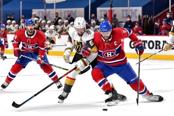 Mark Stone of the Vegas Golden Knights and Shea Weber of the Montreal Canadiens battle for the puck during the first period in Game Three of the...