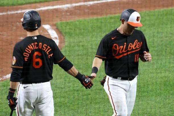 Pat Valaika of the Baltimore Orioles celebrates with Ryan Mountcastle after scoring a run in the fifth inning against the Toronto Blue Jays at Oriole...