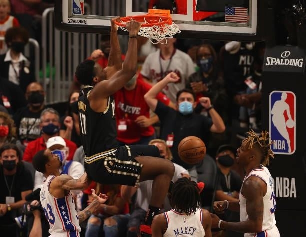 Onyeka Okongwu of the Atlanta Hawks dunks against Dwight Howard, Tyrese Maxey and George Hill of the Philadelphia 76ers during the first half of game...