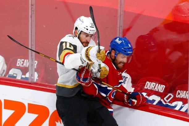 Shea Weber of the Montreal Canadiens is checked into the boards by Nicolas Roy of the Vegas Golden Knights during the first period in Game Three of...