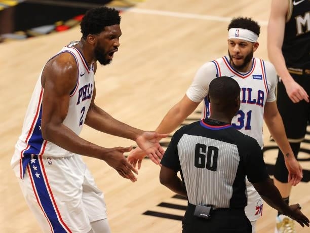 Joel Embiid of the Philadelphia 76ers reacts referee James Williams after being charged with an offensive foul against Clint Capela of the Atlanta...