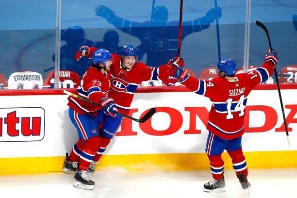 Cole Caufield of the Montreal Canadiens is congratulated by Tyler Toffoli and Nick Suzuki after scoring a goal against the Vegas Golden Knights...