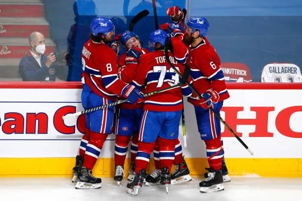 Cole Caufield of the Montreal Canadiens is congratulated by his teammates after scoring a goal against the Vegas Golden Knights during the second...