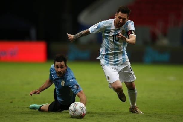 Lionel Messi of Argentina fights for the ball with Matias Viña of Uruguay during a group A match between Argentina and Chile as part of Conmebol Copa...