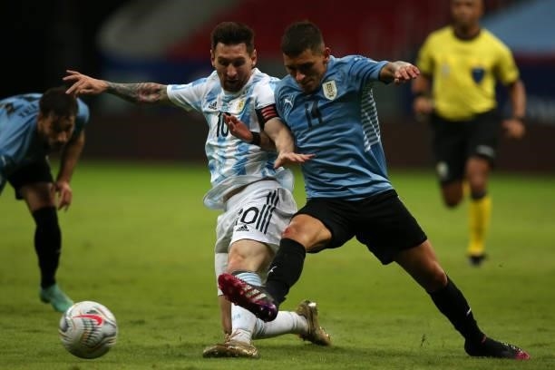 Lionel Messi of Argentina fights for the ball with Lucas Torreira of Uruguay during a group A match between Argentina and Chile as part of Conmebol...