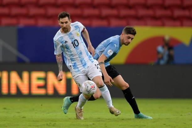 Lionel Messi of Argentina fights for the ball with Matias Viña of Uruguay during a group A match between Argentina and Chile as part of Conmebol Copa...