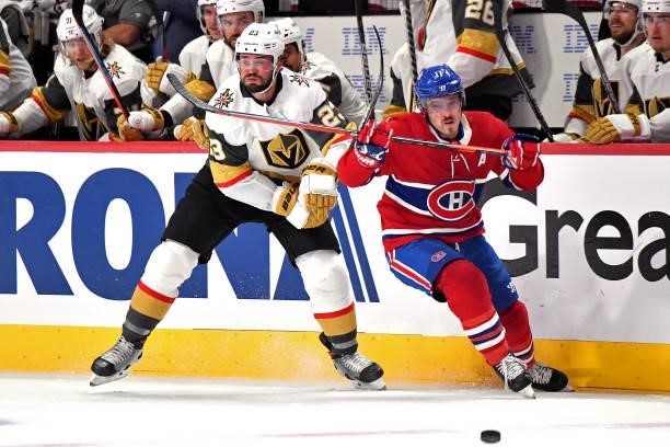 Alec Martinez of the Vegas Golden Knights and Brendan Gallagher of the Montreal Canadiens battle for the puck during the second period in Game Three...