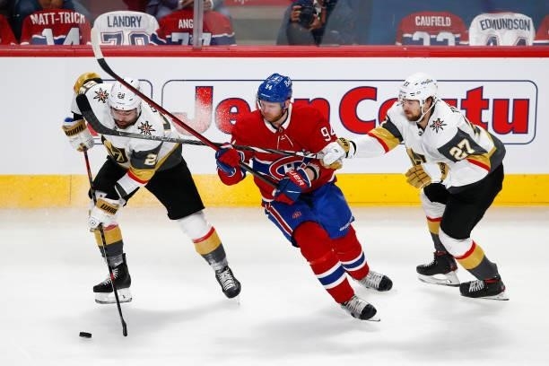 Corey Perry of the Montreal Canadiens battles for the puck with William Carrier and Shea Theodore of the Vegas Golden Knights during the second...