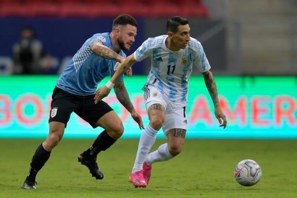 Angel Di Maria of Argentina and Nahitan Nandez of Uruguay compete for the ball during a group A match between Argentina and Chile as part of Conmebol...