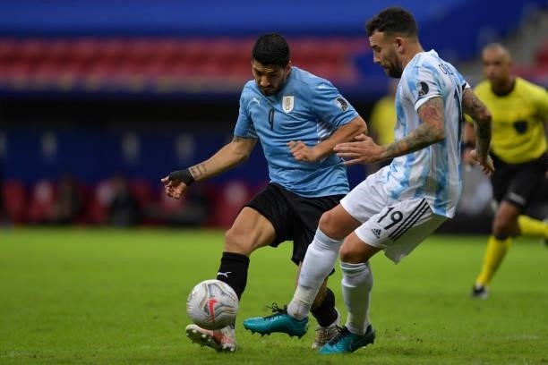 Luis Suarez of Uruguay fights for the ball with Nicolas Otamendi of Argentina during a group A match between Argentina and Chile as part of Conmebol...