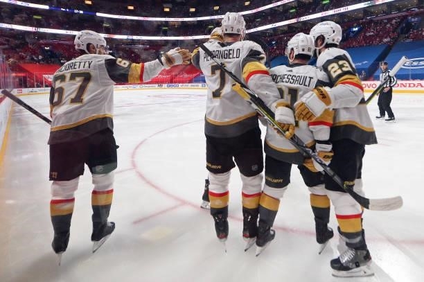 Alex Pietrangelo of the Vegas Golden Knights is congratulated by his teammates after scoring a goal against the Montreal Canadiens during the third...