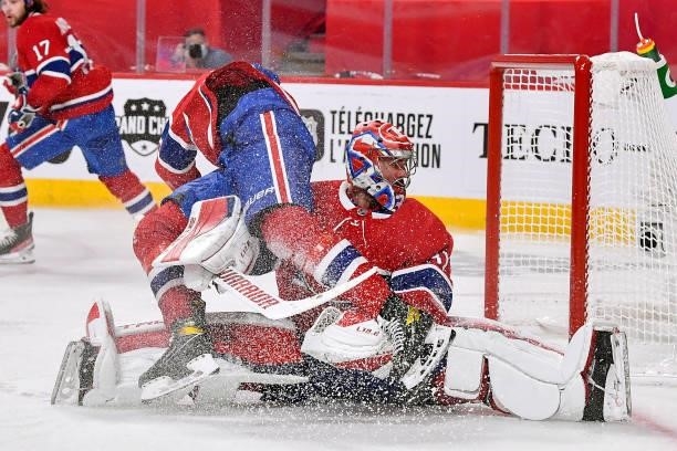 Jesperi Kotkaniemi crashes into teammate Carey Price of the Montreal Canadiens during the third period against the Vegas Golden Knights in Game Three...