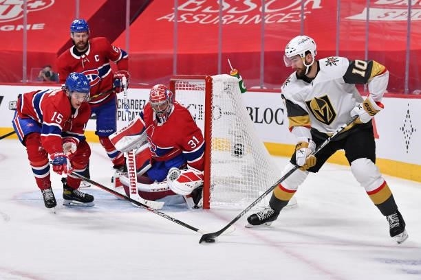 Jesperi Kotkaniemi of the Montreal Canadiens defends Nicolas Roy of the Vegas Golden Knights as Carey Price tends net during the third period in Game...