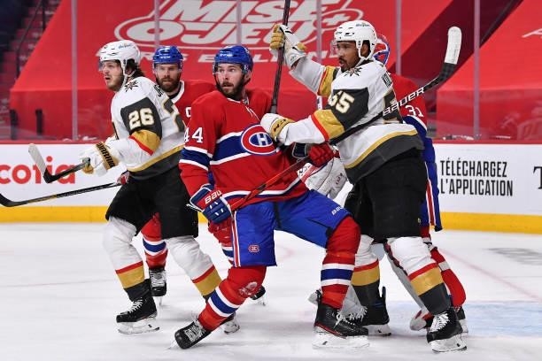 Joel Edmundson of the Montreal Canadiens is checked by Keegan Kolesar of the Vegas Golden Knights during the third period in Game Three of the...