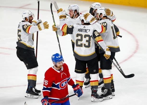 Nicolas Roy of the Vegas Golden Knights is congratulated by his teammates after scoring a goal as Jeff Petry of the Montreal Canadiens reacts during...