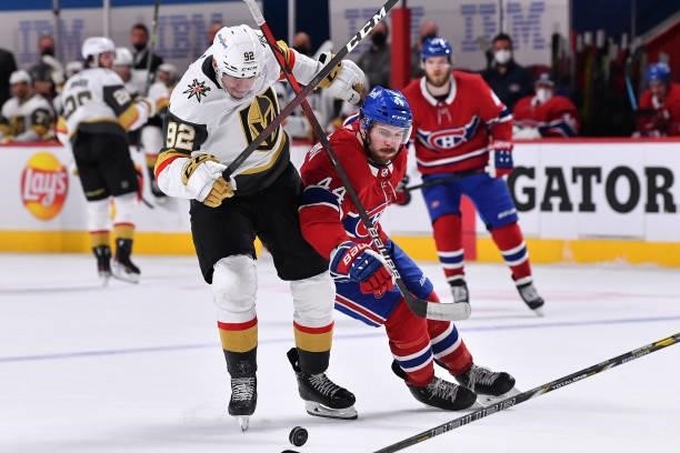 Tomas Nosek of the Vegas Golden Knights and Joel Edmundson of the Montreal Canadiens battle for the puck during the third period in Game Three of the...
