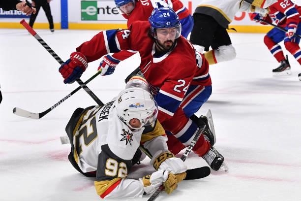 Tomas Nosek of the Vegas Golden Knights is hit by Phillip Danault of the Montreal Canadiens during the third period in Game Three of the Stanley Cup...