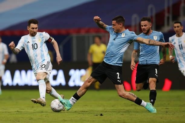 Lionel Messi of Argentina fights for the ball with Jose Gimenez of Uruguay during a group A match between Argentina and Chile as part of Conmebol...