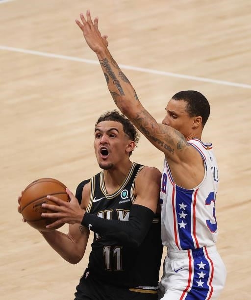 Trae Young of the Atlanta Hawks attempts a shot against George Hill of the Philadelphia 76ers during the second half of game 6 of the Eastern...