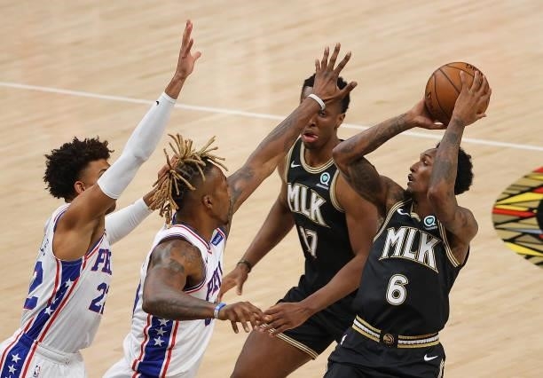 Lou Williams of the Atlanta Hawks attempts a shot against Matisse Thybulle and Dwight Howard of the Philadelphia 76ers during the second half of game...