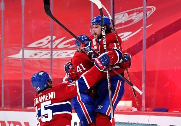 Josh Anderson of the Montreal Canadiens is congratulated by Paul Byron and Jesperi Kotkaniemi after scoring the game-winning goal against the Vegas...