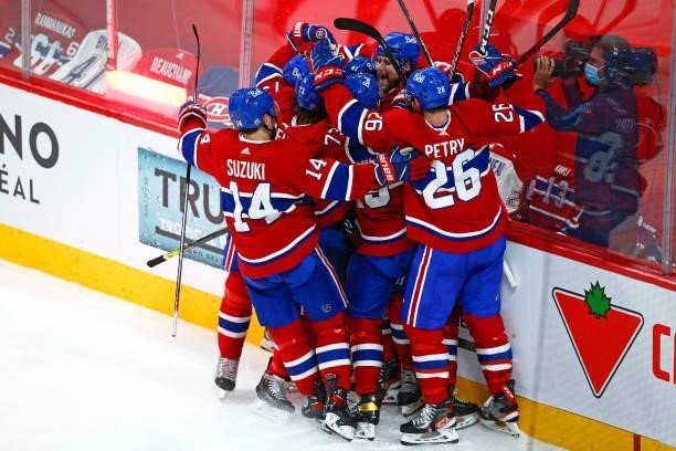 Josh Anderson of the Montreal Canadiens is congratulated by his teammates after scoring the game-winning goal against the Vegas Golden Knights during...