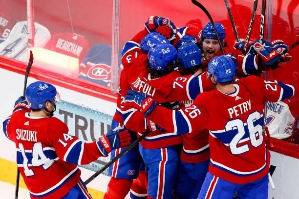 Josh Anderson of the Montreal Canadiens is congratulated by his teammates after scoring the game-winning goal against the Vegas Golden Knights during...