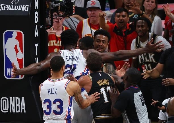Joel Embiid of the Philadelphia 76ers and John Collins of the Atlanta Hawks have an altercation after an offensive foul by Embiid during the second...