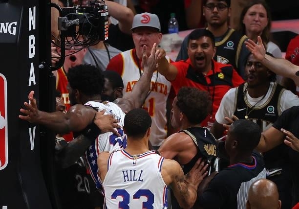 Joel Embiid of the Philadelphia 76ers and John Collins of the Atlanta Hawks have an altercation after an offensive foul by Embiid during the second...