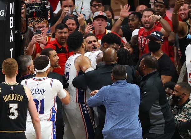 Tobias Harris of the Philadelphia 76ers pulls away Joel Embiid after he and John Collins of the Atlanta Hawks had an altercation after an offensive...