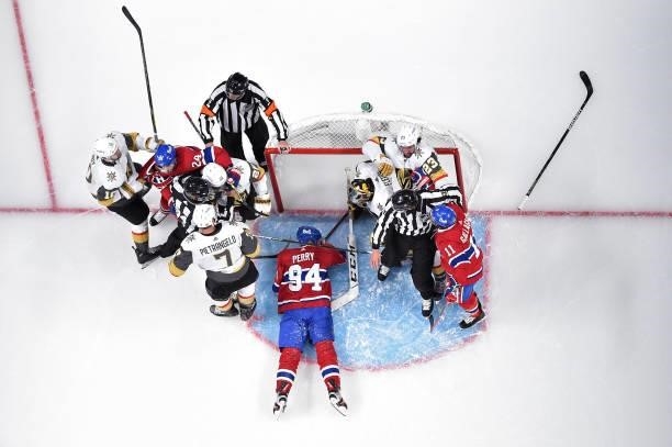 Corey Perry of the Montreal Canadiens gets tripped up against the Vegas Golden Knights as players scuffle during the first period in Game Three of...