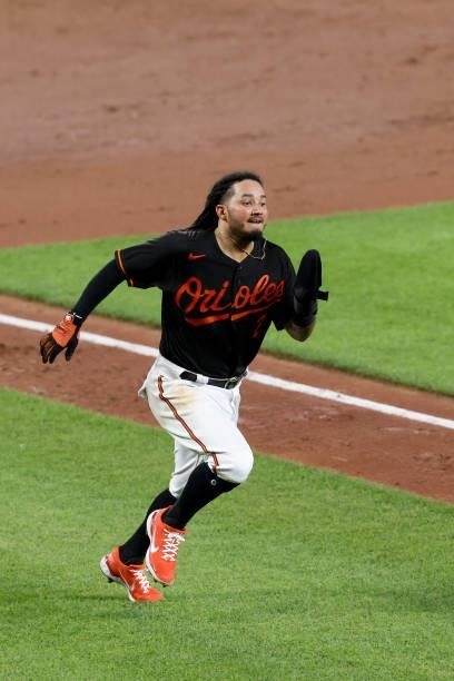 Freddy Galvis of the Baltimore Orioles comes into score against the Toronto Blue Jays in the eighth inning at Oriole Park at Camden Yards on June 18,...