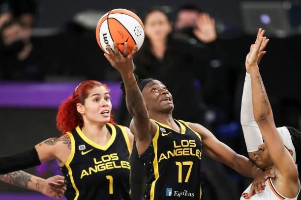Guard Erica Wheeler of the Los Angeles Sparks shoots over guard Shey Peddy of the Phoenix Mercury in the second half at Los Angeles Convention Center...