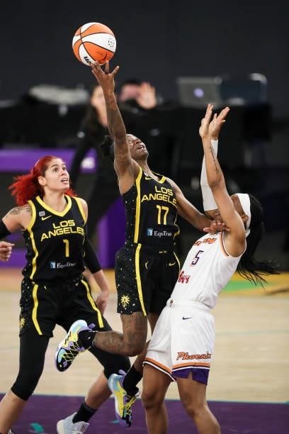 Guard Erica Wheeler of the Los Angeles Sparks shoots over guard Shey Peddy of the Phoenix Mercury in the second half at Los Angeles Convention Center...