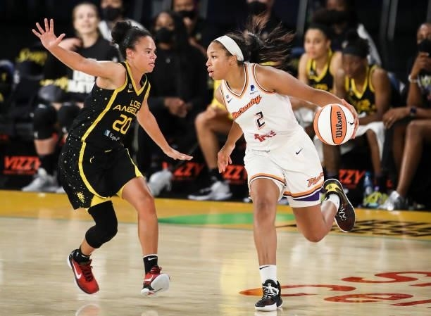 Forward Megan Walker of the Phoenix Mercury handles the ball defended by guard Kristi Toliver of the Los Angeles Sparks at Los Angeles Convention...