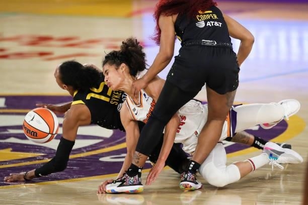 Guard Brittney Sykes of the Los Angeles Sparks and guard Skylar Diggins-Smith of the Phoenix Mercury get tangled pursuing a loose ball during the...