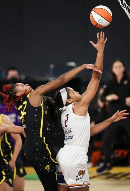 Forward Megan Walker of the Phoenix Mercury is fouled by guard Bria Holmes of the Los Angeles Sparks during the first half at Los Angeles Convention...