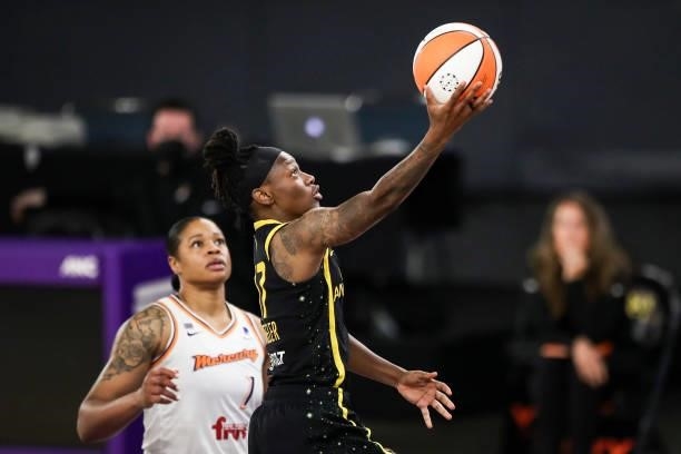 Guard Erica Wheeler of the Los Angeles Sparks drives to the basket ahead of center Kia Vaughn of the Phoenix Mercury at Los Angeles Convention Center...