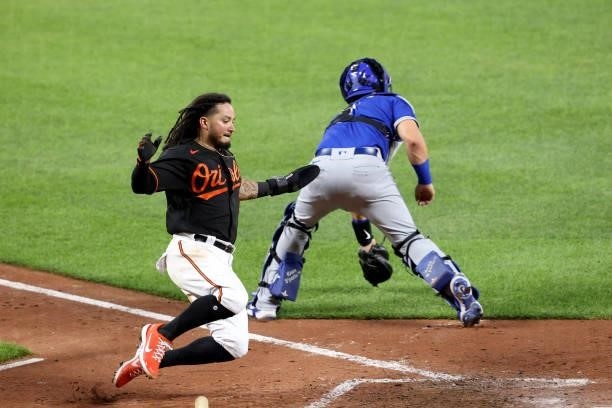 Freddy Galvis of the Baltimore Orioles comes into score against the Toronto Blue Jays in the eighth inning at Oriole Park at Camden Yards on June 18,...
