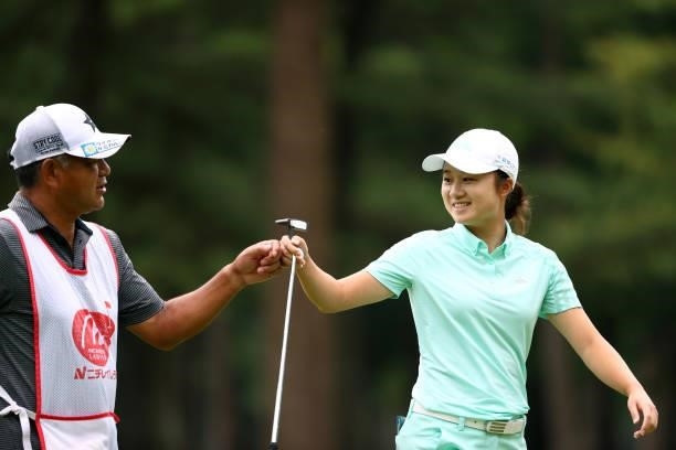 Haruka Morita of Japan fist bumps with her caddie after the birdie on the 15th green during the second round of Nichirei Ladies at Sodegaura Country...
