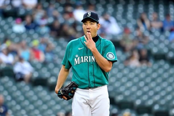 Yusei Kikuchi of the Seattle Mariners licks his fingers during the game against the Tampa Bay Rays at T-Mobile Park on June 18, 2021 in Seattle,...
